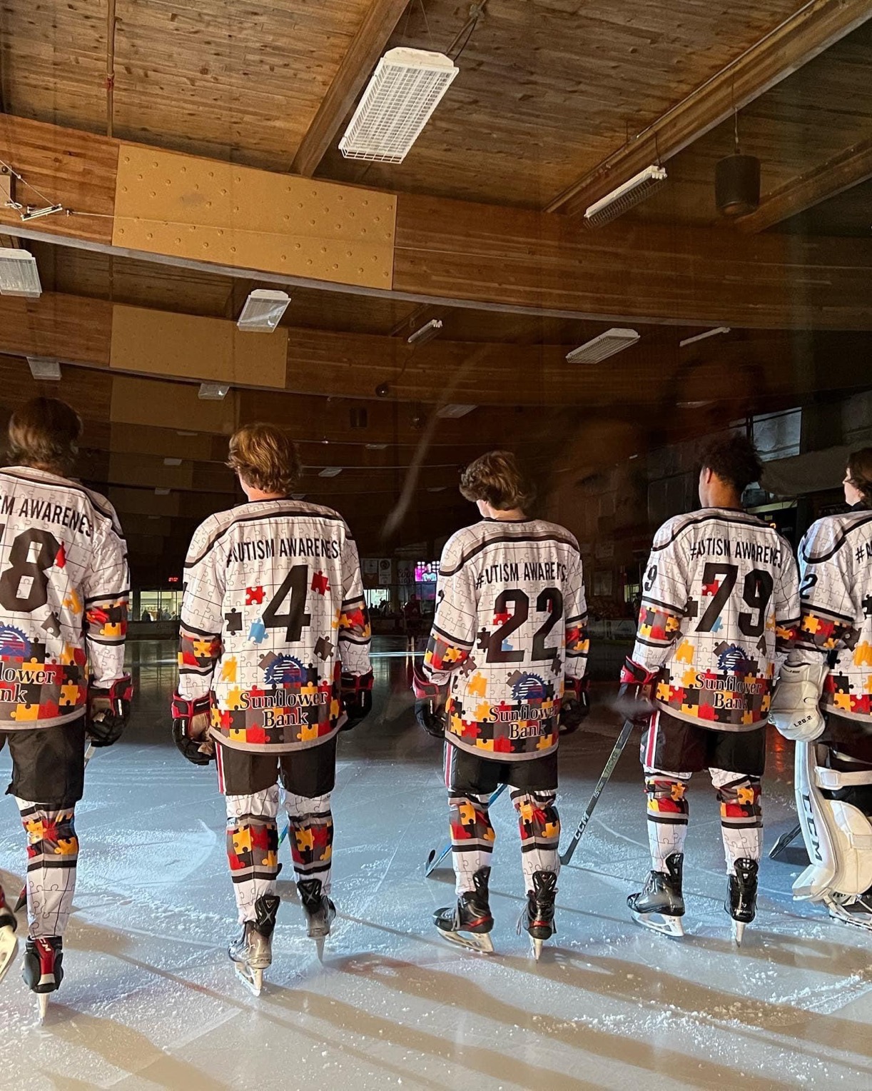 Pueblo Bull's hockey players standing on ice