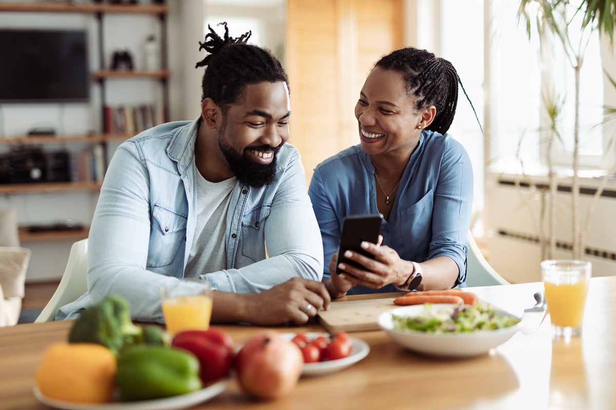 man smiling next to woman