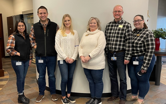 Group of 6 people with sets of two in matching outfits