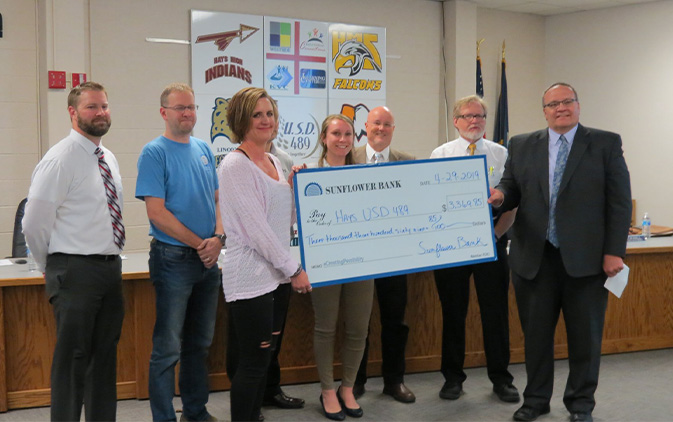 group of employees presenting a large check