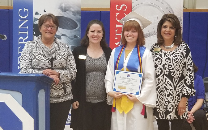 four women standing by podium