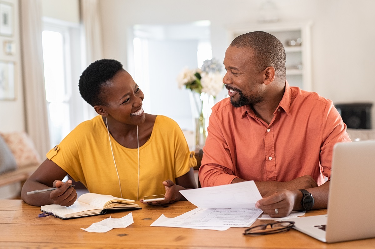 man and woman smiling with writing something