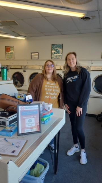 two woman in a laundromat